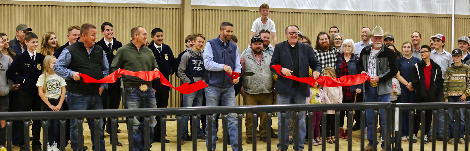 All community members were invited to participate in the Hugh Ragsdale Agri-science Activity Center ribbon-cutting on Monday evening. School Board Presi- dent Jason Stovall does the honors.